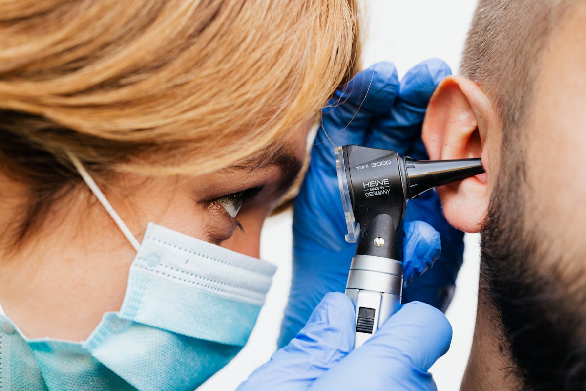 Doctor performing an ear examination on a patient
