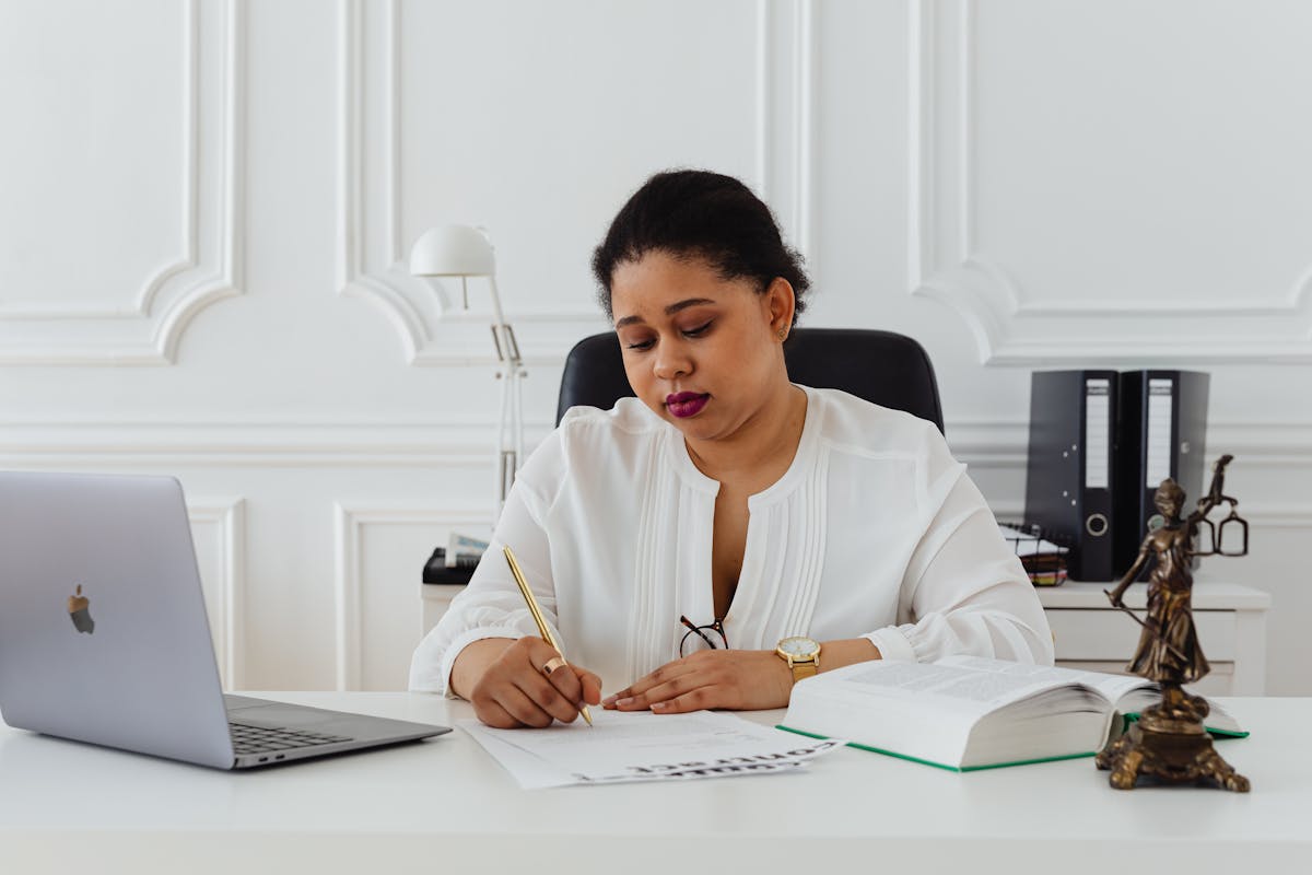 Lawyer reviewing estate planning documents with client at desk - Shannon Neely Financial estate planning