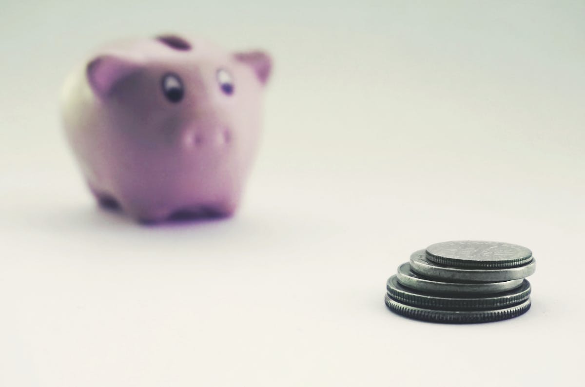 Piggy bank with coins representing RRSP TFSA government-sponsored savings and investment plans Canada