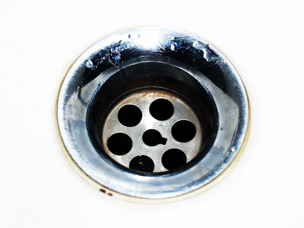 Close-up of stainless steel sink drain - strange plumbing odors source Bayshore Plumbing Belleville