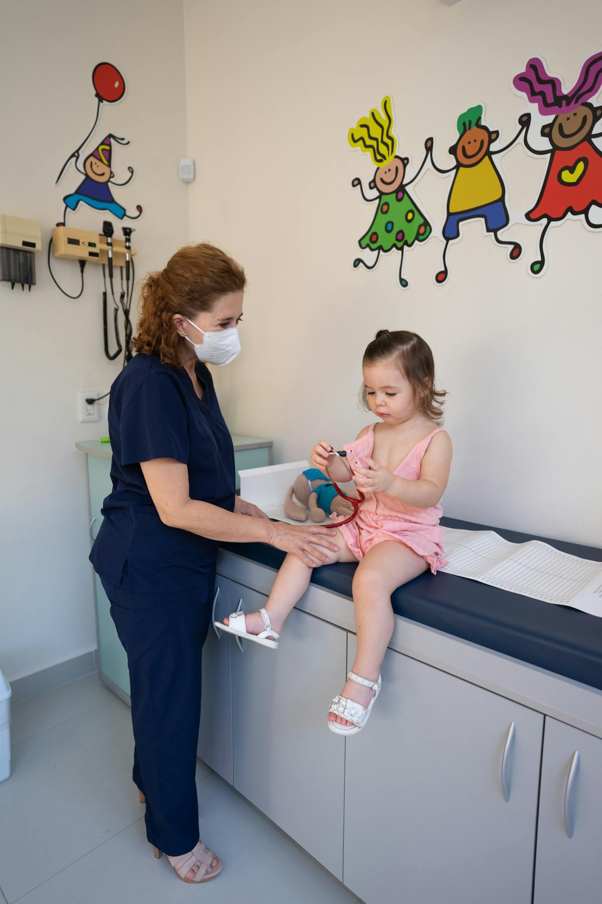 Doctor examining a young girl patient in pediatric clinic - Canadian Shriners Hospital 100 years