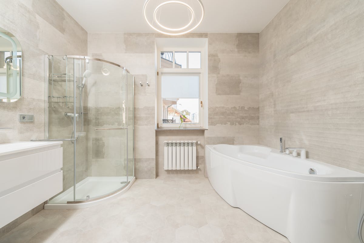 Contemporary bathroom with glass shower and elegant tile work - Breelan Construction bathroom renovation Belleville