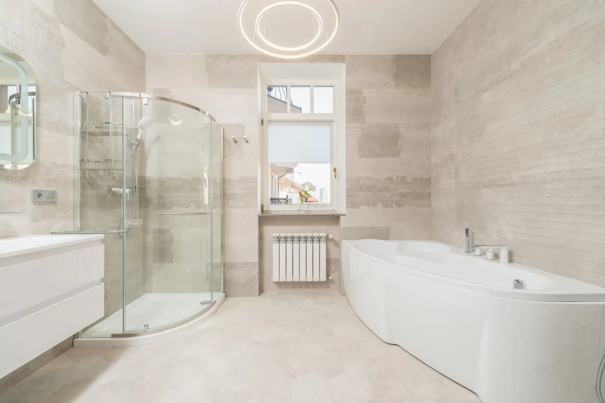 Contemporary bathroom with glass shower and elegant tile work - Breelan Construction bathroom renovation Belleville