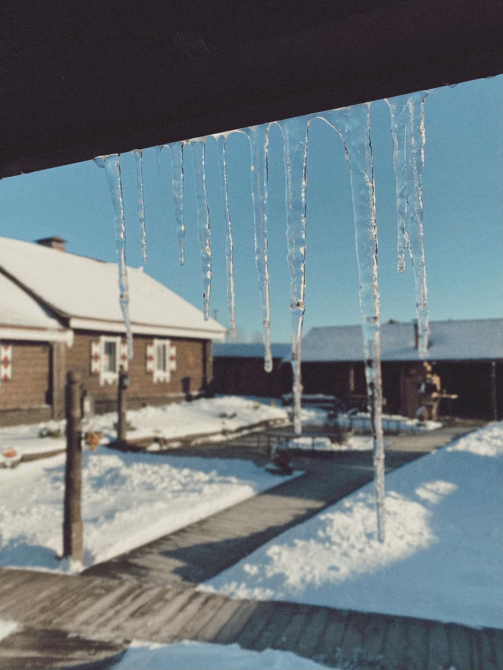 Icicles hanging from roof eaves in Ontario winter - frozen pipe risk and plumbing winterization Bayshore Plumbing