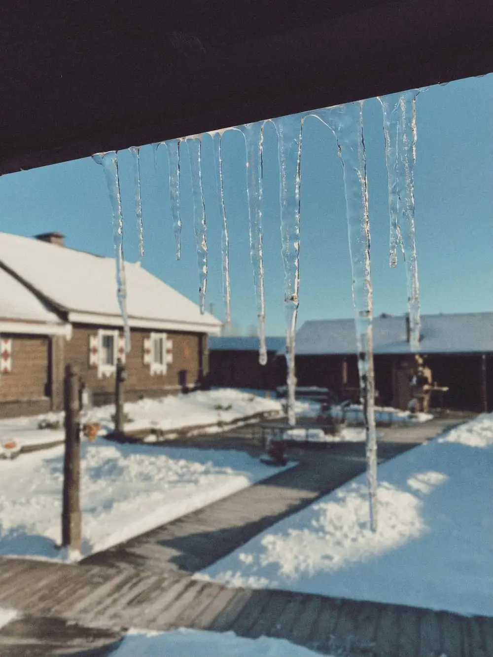 Icicles hanging from roof eaves in Ontario winter - frozen pipe risk and plumbing winterization Bayshore Plumbing
